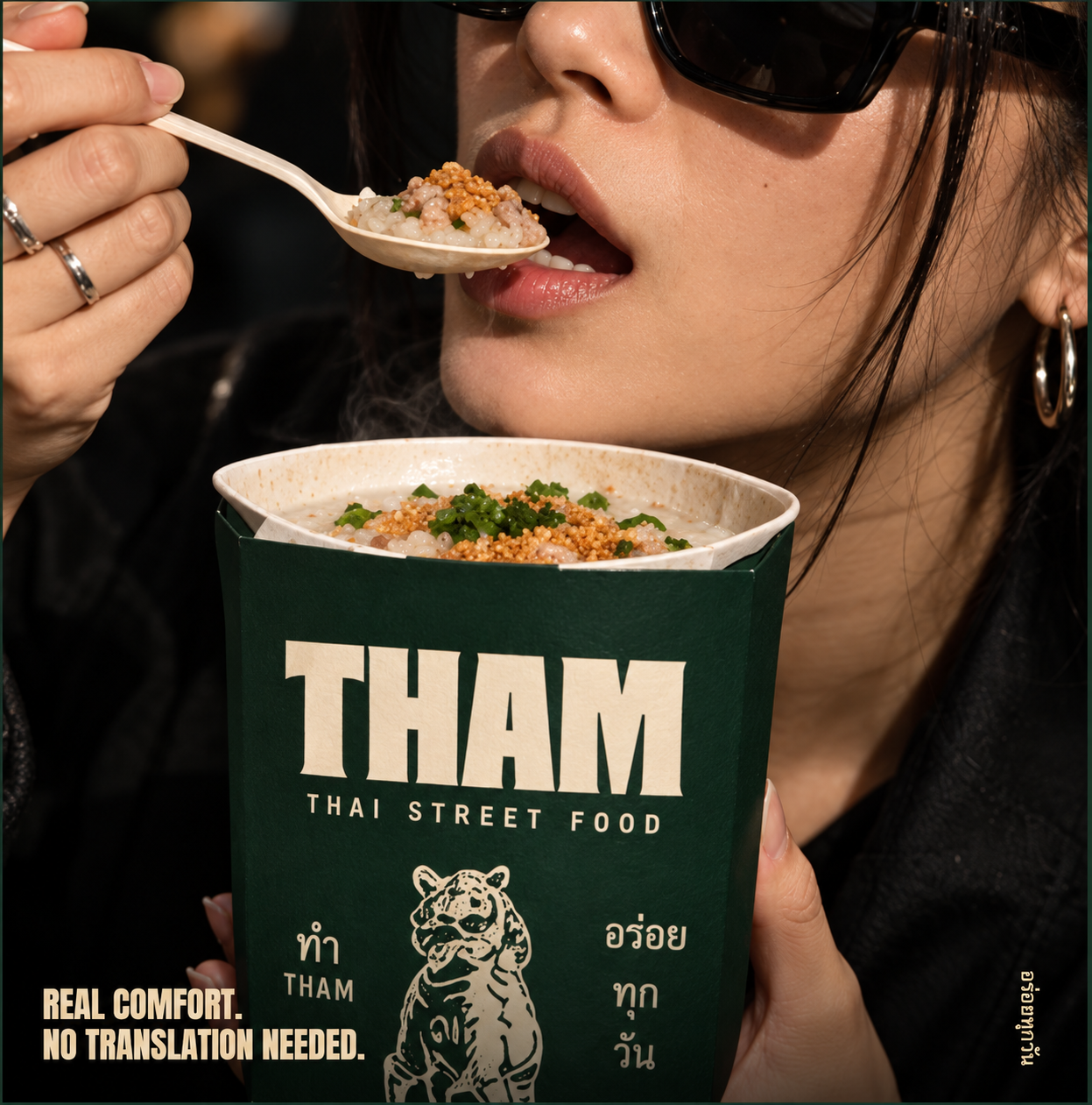 A diner enjoying Khao Tom from a THAM cup. Real comfort. No translation needed.
